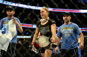 UFC champion Ronda Rousey holding a can of Xyience in the ring after a bout in California.