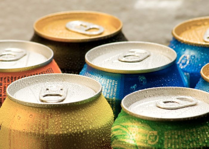 Cans of soft drink. Cooling frozen and with water drops